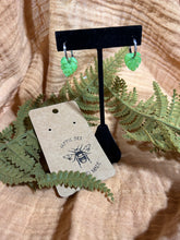 Load image into Gallery viewer, Shimmery green monstera leaf silver huggie hoops
