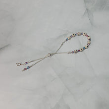Load image into Gallery viewer, Sheet Music Slider Knot Paper Bead Bracelet w/ pink/blue glass spacer beads &amp; silver music note charm
